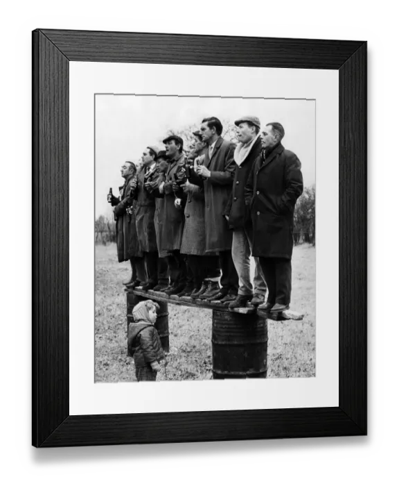 Framed Print : A plank and two oil drums make up a lofty if precarious vantage point for these