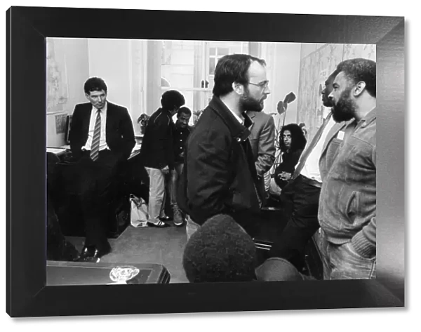Derek Hatton looks on as he is imprisoned in his council office by members of the Black