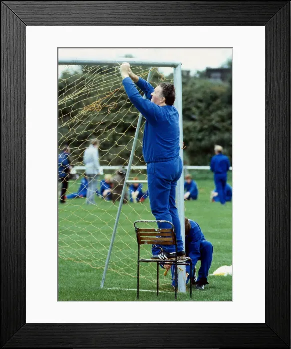 Framed Print : Jock Stein tying up nets to goals 1985