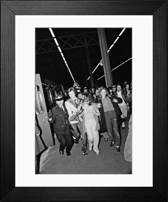Framed Print : British pop singer David Boowie greeted by crowds of fans at Charing Cross Station