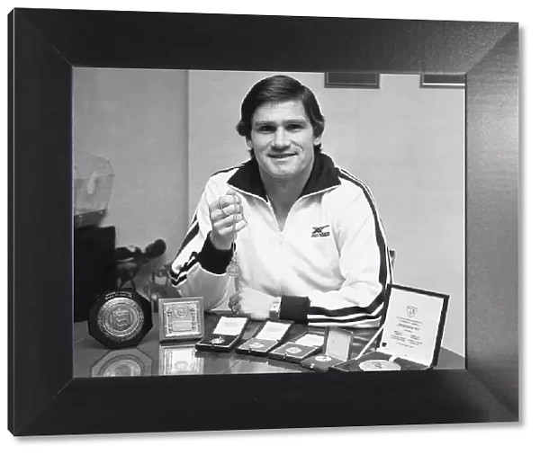 Arsenal footballer Pat Rice shows off his trophies, February 1983