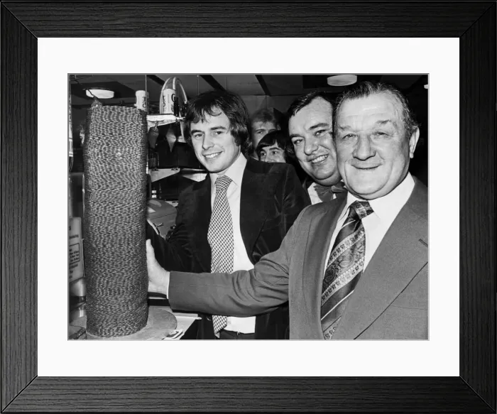 Framed Print : Liverpool manager Bob Paisley helps Nick Owen of BBC radio Birmingham transfer a pile of