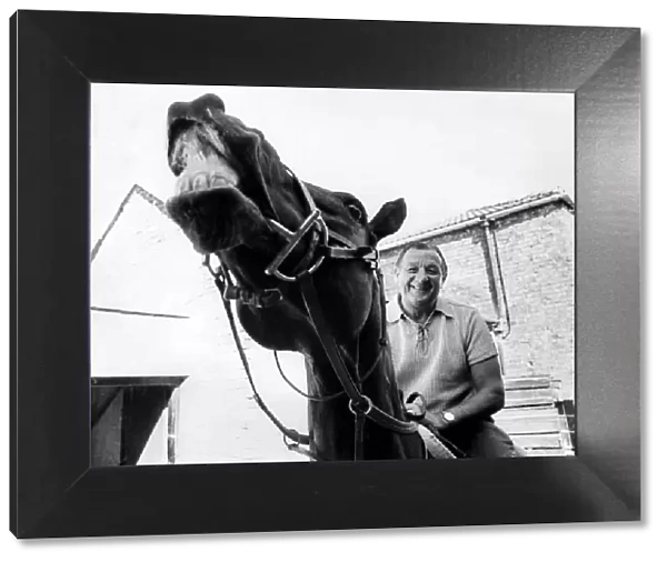 Liverpool manager Bob Paisley pictured on a racehorse at a racing stables. June 1976