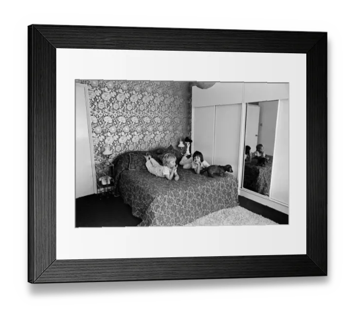 Framed Print : Two children and a dog on a bed in a display of a modern bedroom, 12th May 1969