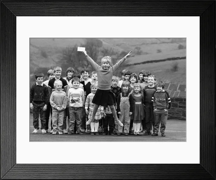 Framed Print : Jumping for joy after raising money for the appeal is young Olivia Rayner