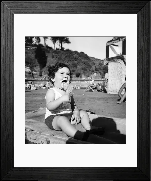 Framed Print : Baby absorbed in the serious business of consuming an ice cream Framed Print : Baby absorbed in the serious business of consuming an ice cream