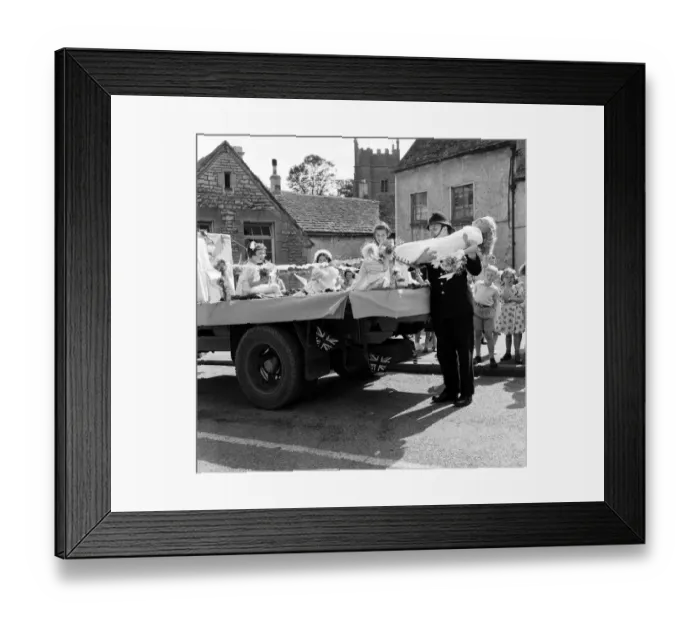 Framed Print : Village Fete in Horsley, Gloucestershire. The local police constable PC Batsons lifts