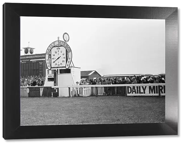 Racegoers gather at the finishing post during the Andy Capp Handicapp race meeting at