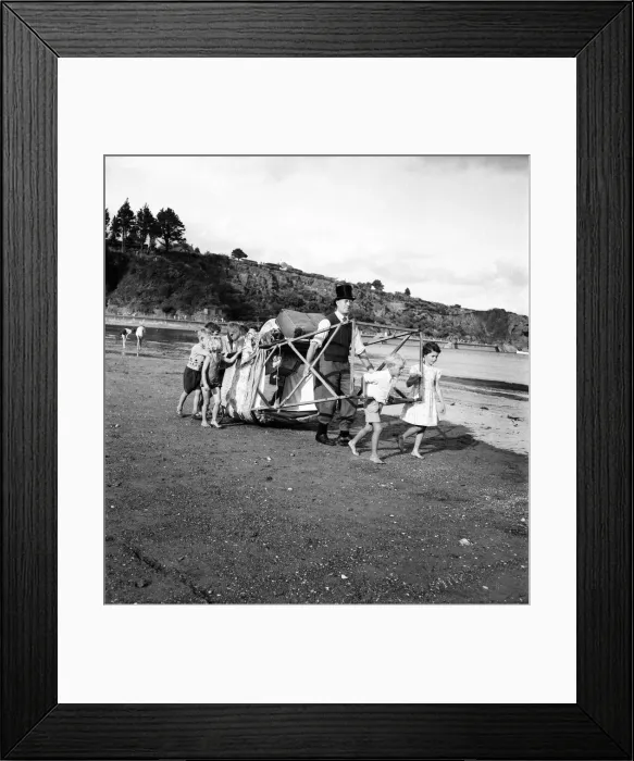 Framed Print : Punch and Judy Show. After putting their pennies in his old top hat the appreciative