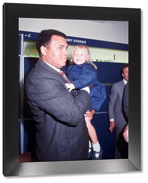 Muhammad Ali seen here with four year old Hannah Clarke during a book signing session at