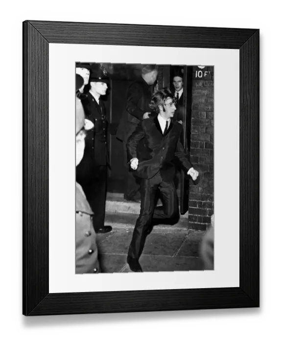 Framed Print : Beatles drummer Ringo Starr bolts from a side exit to a waiting car after the band Framed Print : Beatles drummer Ringo Starr bolts from a side exit to a waiting car after the band