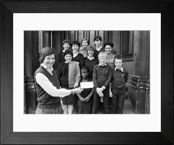 Framed Print : Teacher Miss Sally Cox displays a £65 cheque for the Huddersfield Hospice Appeal Framed Print : Teacher Miss Sally Cox displays a £65 cheque for the Huddersfield Hospice Appeal