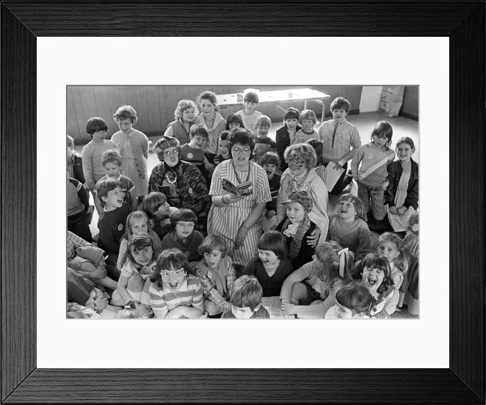 Framed Print : These Lepton Children enjoy a Super Hero'story read to them by library