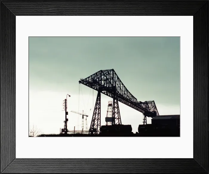 Framed Print : Tees Transporter Bridge, Middlesbrough, silhouetted against the midday sky Framed Print : Tees Transporter Bridge, Middlesbrough, silhouetted against the midday sky