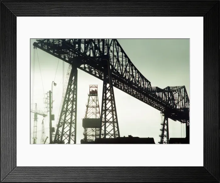 Framed Print : Tees Transporter Bridge, Middlesbrough, silhouetted against the midday sky Framed Print : Tees Transporter Bridge, Middlesbrough, silhouetted against the midday sky