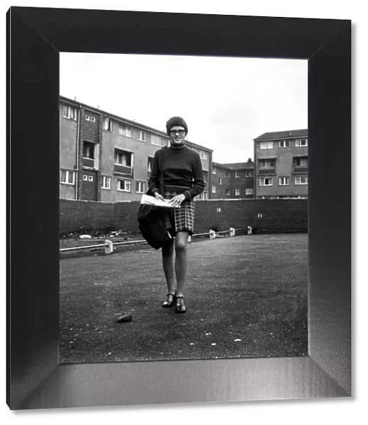 Teenage girl from Toxteth in Liverpool, Merseyside, delivering newspapers on a paper