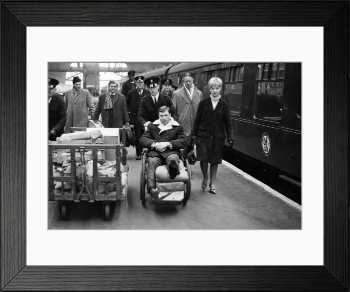 Framed Print : Charlton Athletic footballer Mike Bailey returns to London with his wife after breaking Framed Print : Charlton Athletic footballer Mike Bailey returns to London with his wife after breaking