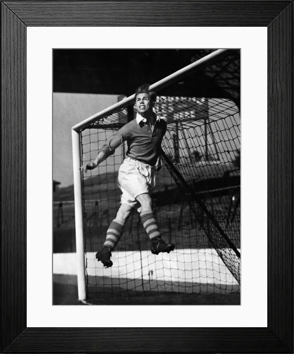 Framed Print : Charlton Athletic left half Bert Johnson practicing heading the ball out from under