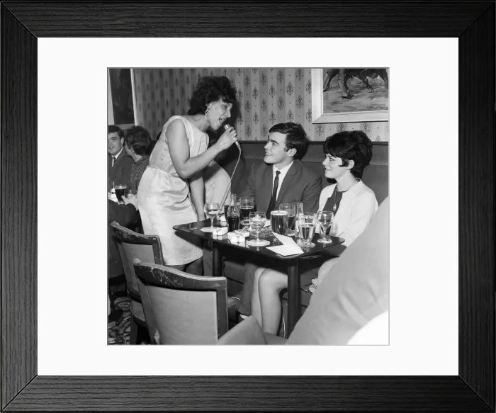 Framed Print : A couple get the treatment from a singer in Dundee Lounge Bar. 6th June 1967 Framed Print : A couple get the treatment from a singer in Dundee Lounge Bar. 6th June 1967