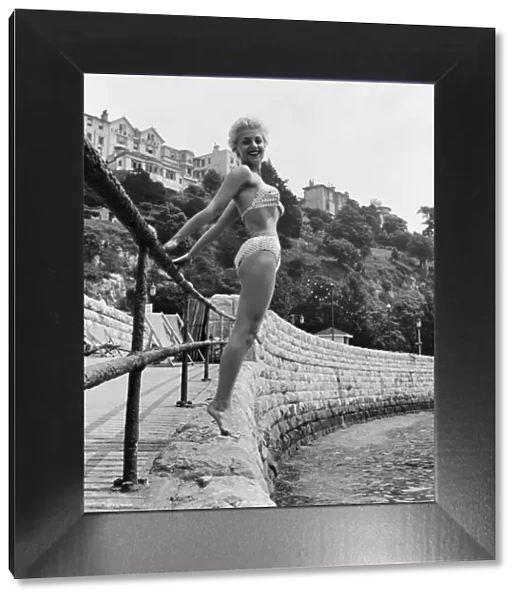Twenty three year old Anita Curzon of London poses holding onto a railing in her bikini