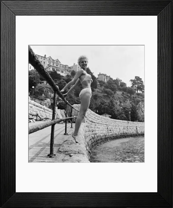 Framed Print : Twenty three year old Anita Curzon of London poses holding onto a railing in her bikini Framed Print : Twenty three year old Anita Curzon of London poses holding onto a railing in her bikini