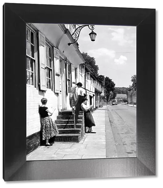 Women of West Wycombe in Buckinghamshire standing in the street making sketches of local