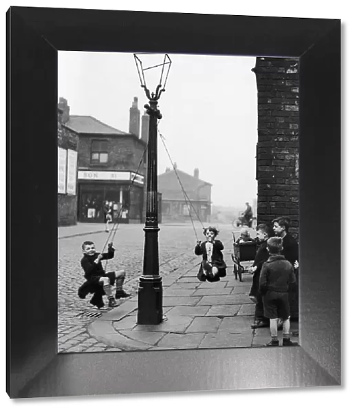 Children in a Manchester Street find their own enjoyment with the aid of a rope