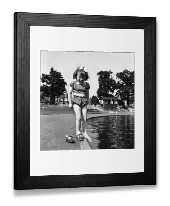 Framed Print : Holidays, little girl modelling swimsuit. June 1953 D3299-002