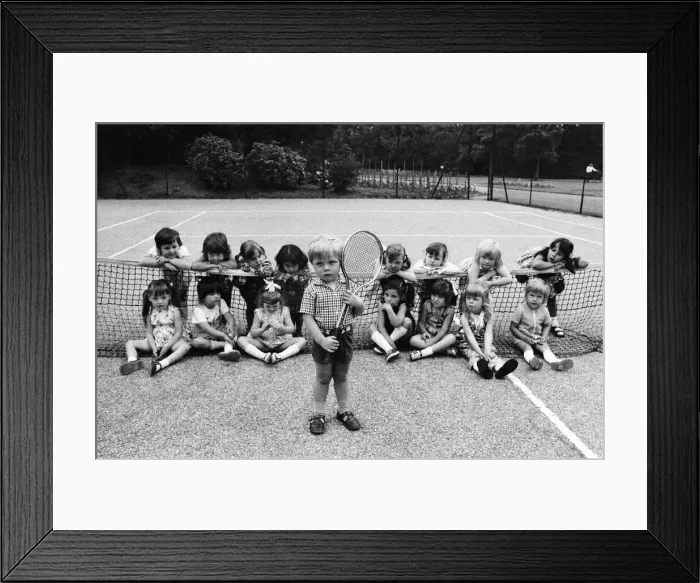 Framed Print : Three year old Daniel Jarmin holds a tennis racket as he poses with other friends in his