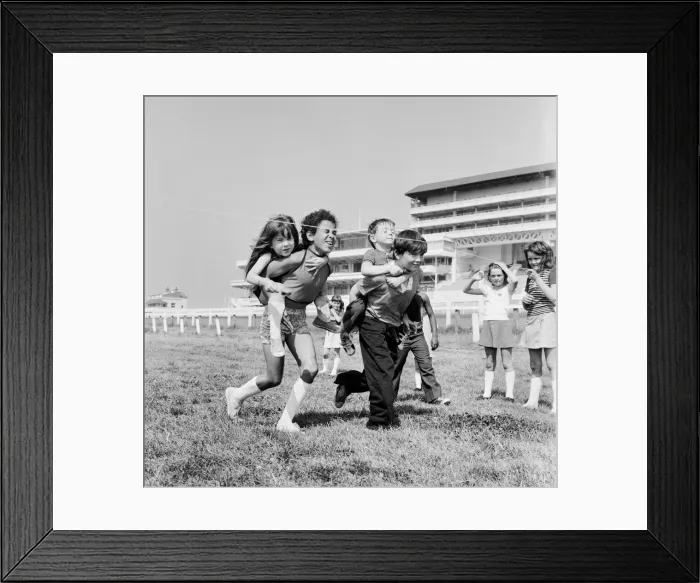 Framed Print : Children carrying their partners on their backs during a horse and jockey style egg Framed Print : Children carrying their partners on their backs during a horse and jockey style egg