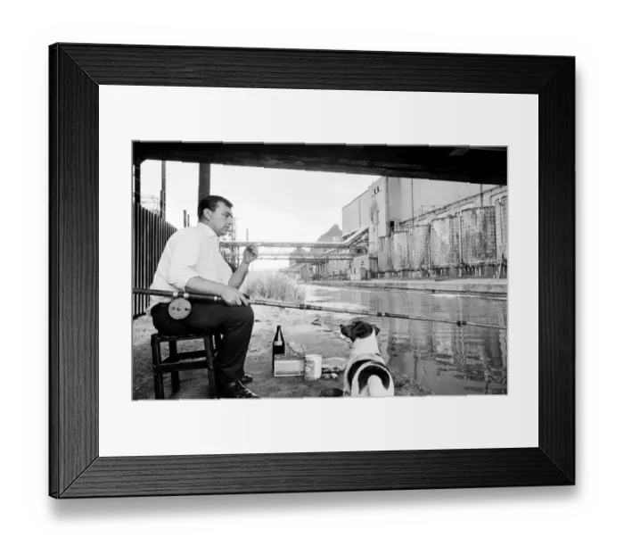 Framed Print : This man enjoys a smoke as he waits patiently for a bite Framed Print : This man enjoys a smoke as he waits patiently for a bite