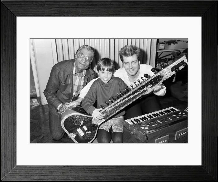 Framed Print : Martine Bochat (centre) gets a lesson on the sitar from Virendra Bhatt (left Framed Print : Martine Bochat (centre) gets a lesson on the sitar from Virendra Bhatt (left
