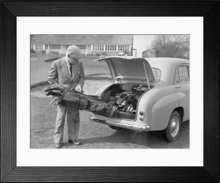 Framed Print : Golfer seen here storing his golf clubs in the boot of his brand new Standard 8 car Circa