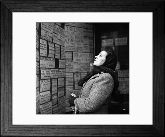 Framed Print : A woman looking for a tailoring job in the East End of London. March 1954 Framed Print : A woman looking for a tailoring job in the East End of London. March 1954