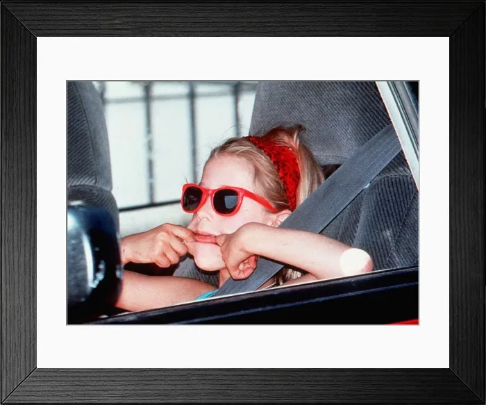 Framed Print : Paula Yates daughter-Peaches in red sunglasses pulling face in back of car on way to Framed Print : Paula Yates daughter-Peaches in red sunglasses pulling face in back of car on way to