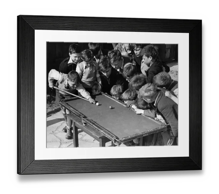 Framed Print : Sixteen tousled heads bend over a rickety billiard table at the Camel club, Bethnal Green