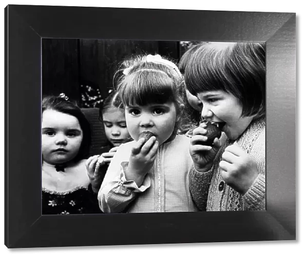 Children eating chocolate easter eggs, 27th March 1975