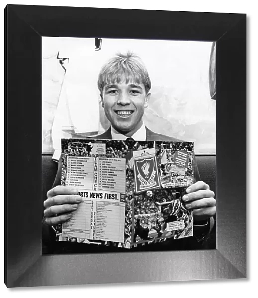 Swansea City footballer Andy Legg holding a football programme ahead of his side