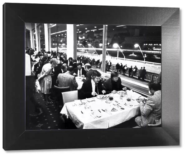 Diners enjoying their meal at Belle Vue Greyhound stadium while punters line trails