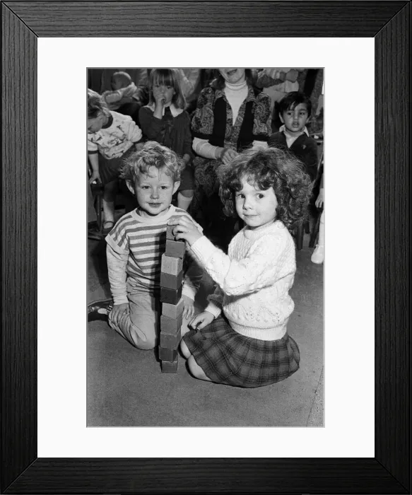 Framed Print : Helping raise money for new toys at their playgroup are three-year-old Simon Gerrard Framed Print : Helping raise money for new toys at their playgroup are three-year-old Simon Gerrard