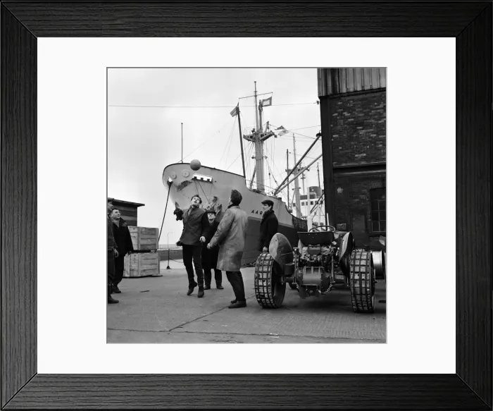 Framed Print : Its dinner break at the docks and these dockers get the ball out for a kick about in