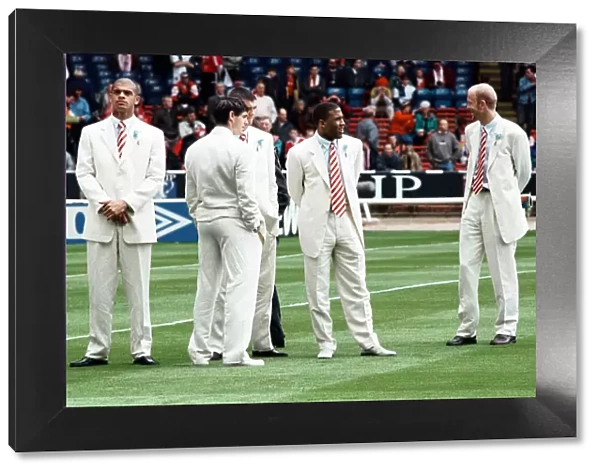 Mark Wright (right) and John Barnes with fellow Liverpool team mates on the pitch at