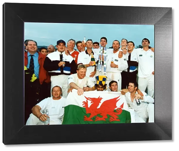 Glamorgan celebrate their championship with trophy, champagne - and the national flag