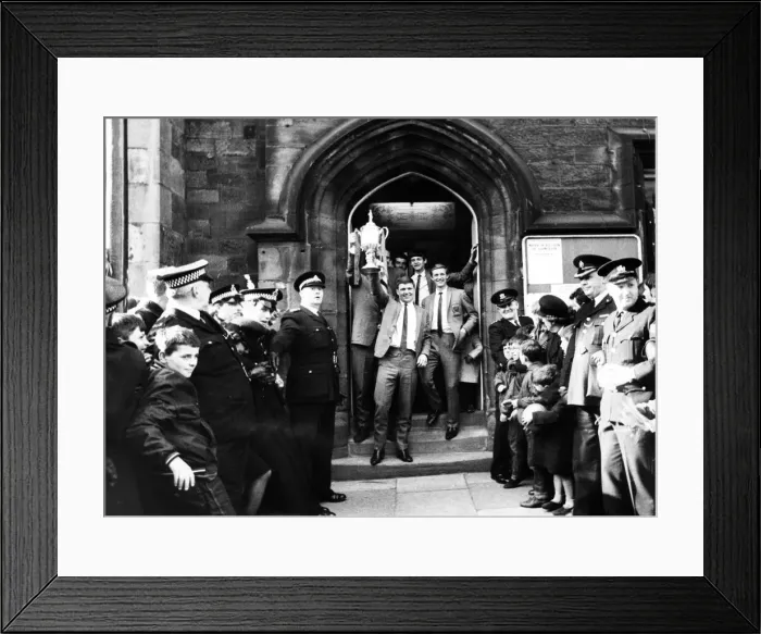 Framed Print : Ron Tatum carries the trophy as he and the members of the team leave the town hall Framed Print : Ron Tatum carries the trophy as he and the members of the team leave the town hall