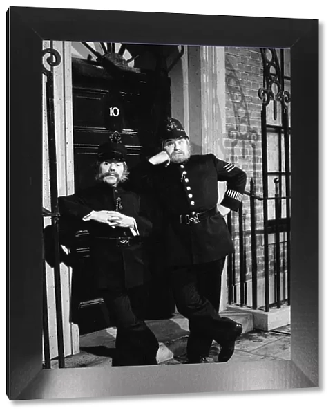Ronnie Corbett and Ronnie Barker dressed as policemen on duty outside 10 Downing Street