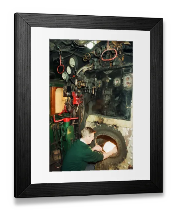 Framed Print : ICI Train Preservation, 4th January 1994. Dave Pearson, examines the fire box of the Blue Framed Print : ICI Train Preservation, 4th January 1994. Dave Pearson, examines the fire box of the Blue