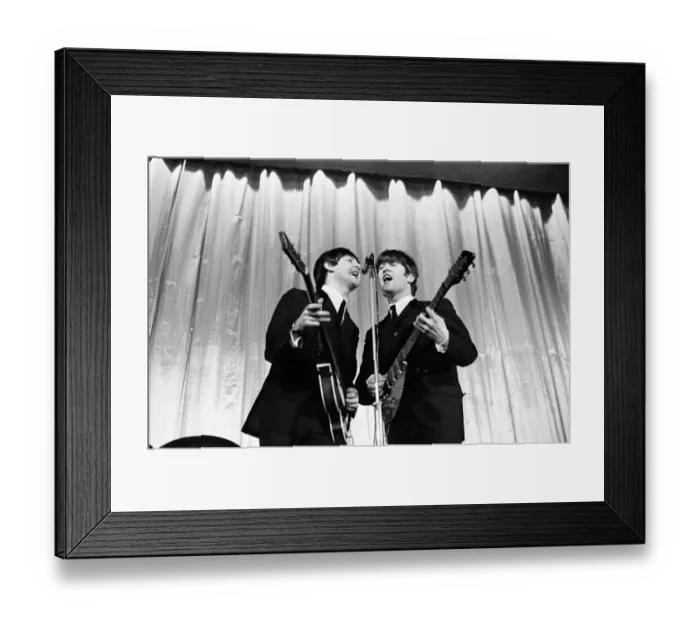 Framed Print : Paul McCartney and John Lennon sharing the microphone during a performance by British pop