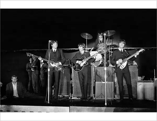 The Beatles performing on stage at the Forest Hills Tennis Stadium in New York during