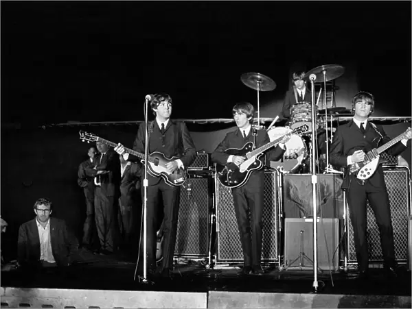 The Beatles performing on stage at the Forest Hills Tennis Stadium in New York during