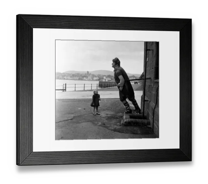 Framed Print : Little Susan Bond, 4, looks at the wooden figurehead of the Saint George Framed Print : Little Susan Bond, 4, looks at the wooden figurehead of the Saint George